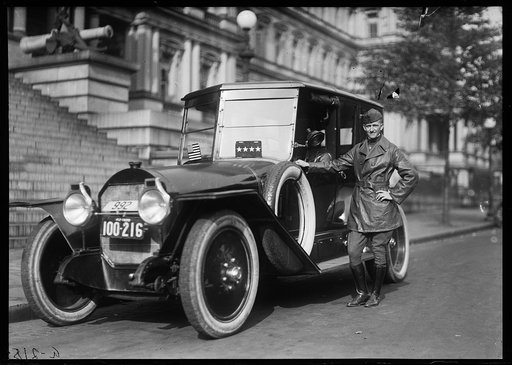 Man with automobile in front of State, War and Navy Building, Washington, D.C.