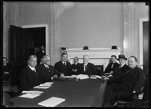 Group at table; Hiram Johnson, left