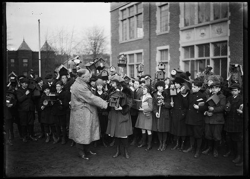 Group of children with bird houses; building in background is the Wilson Normal School, Harvard Street and 11th St., Washington, D.C.