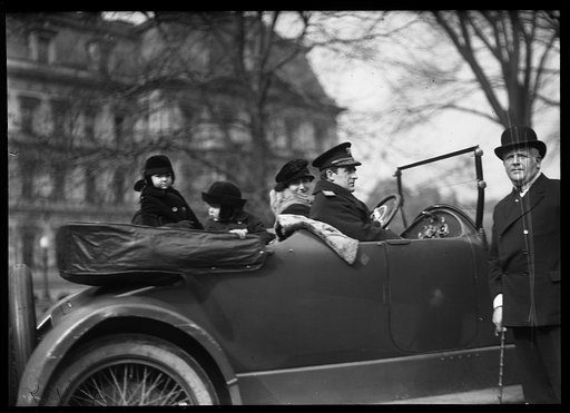 Family group in automobile; State, War and Navy Building in background. Washington, D.C.