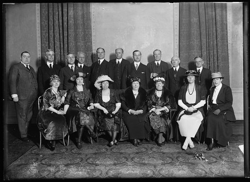 Group of men and women; back row: Cordell Hull, left; Homer S. Cummings, center
