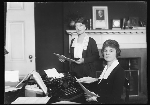 Women at work in office; Harding portrait on mantle