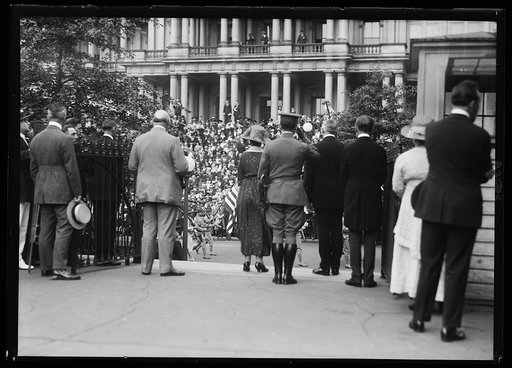 Rear view of group, including John Weeks?, Florence Harding, Warren Harding facing group at State, War, and Navy Building, Washington, D.C.