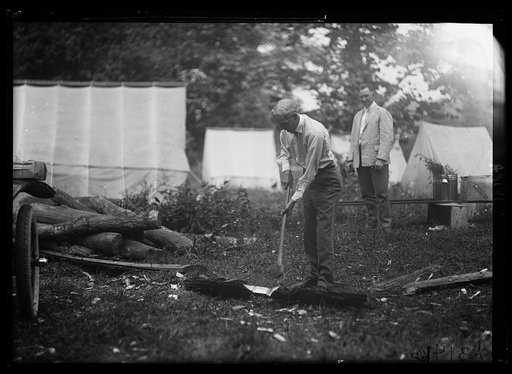 Henry Ford chopping wood at Firestone camp