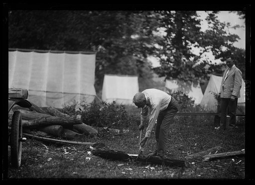 Henry Ford chopping wood at Firestone camp
