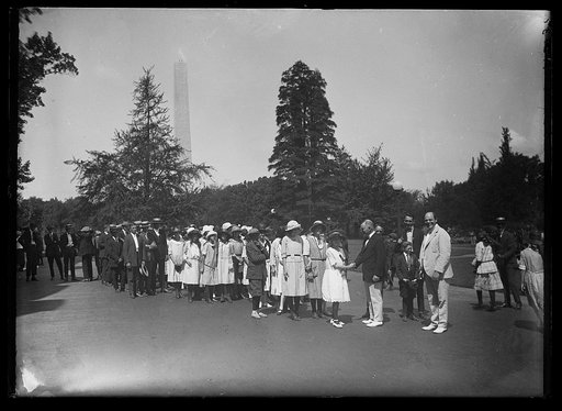 Group of persons, Washington Monument in background. Washington, D.C.