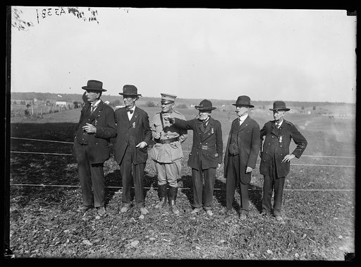 Several Civil War veterans watched the Marines in their maneuvers at Wilderness, Va. in 1921. Here they are pointing out the chief spots of the battleground to General Lejeune, the Commandant of the Marine Corps