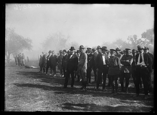 Spectators including President Harding, General Lejeune and Harding's physician, Dr. Charles E. Sawyer, during the Marine maneuvers at Wilderness Battlefield, Virginia, Oct. 1921