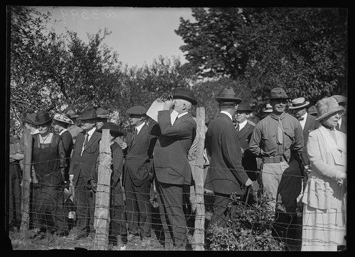 President Warren Harding, looking through binoculars during the Marine maneuvers at Wilderness Battlefield, Virginia, Oct. 1921