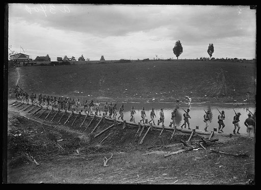 Soldiers walking over a dam, built by engineers of the U.S. Marine Corps, during the Marine maneuvers at Wilderness Battlefield, Virginia, Oct. 1921