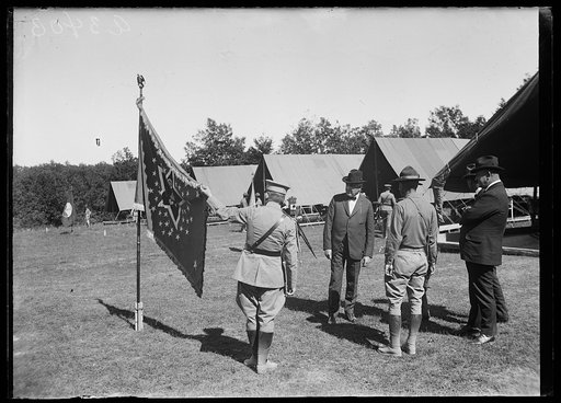 General John Lejeune holding up the President's flag at Marine Headquarters during the Marine maneuvers at Wilderness Battlefield, Virginia, Oct. 1921 