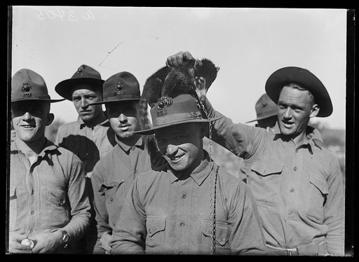 Marines with a coati during the Marine maneuvers at Wilderness Battlefield, Virginia, Oct. 1921