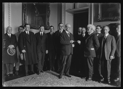 Secy. Hughes being presented with a pair of gold shears on behalf of the newspapermen covering the State Dept.