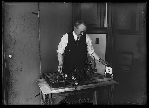 C. Francis Jenkins, Washington inventor in his laboratory with the receiving in instrument of his latest invention which will make possible the transmission of moving pictures by radio