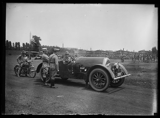 Military group at camp and automobile; Washington Monument in background