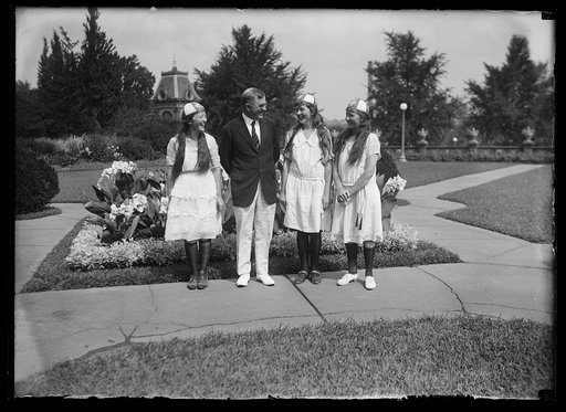 Henry C. Wallace and group of girls at garden