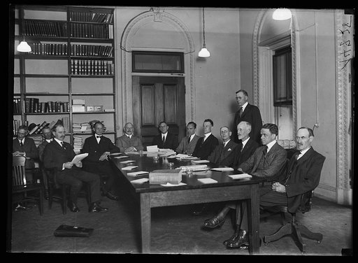 Group at table; John W. Weeks at head of table