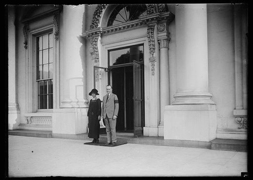 Grace and Calvin Coolidge standing at entrance to White House, Washington, D.C.