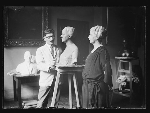 Sculptor sculpting bust of woman