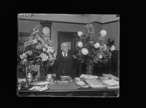 Samuel Gompers at desk with flowers