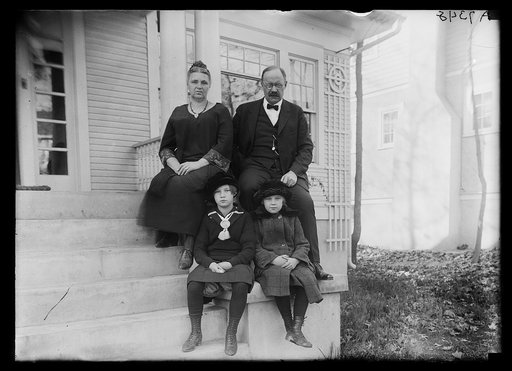 Magnus Johnson with family? on front porch of house