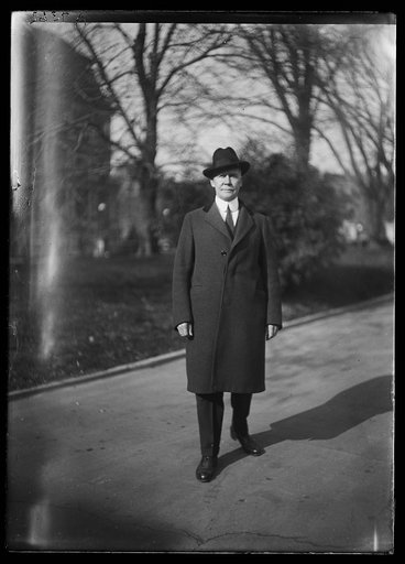 Man at White House; State, War and Navy Building in background. Washington, D.C.