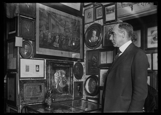 Man looking at collection of Lincoln pictures