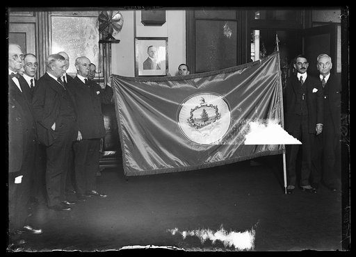 Group with flag; Harry S. New, third from left