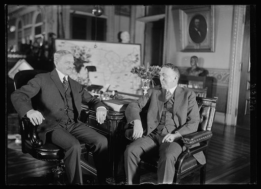 Gen. John J. Pershing, Chief of Staff, at his desk in the War Dept. for the first time since his return from France, conferring with Major Cen. John L. Hines, Deputy Chief of Staff
