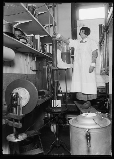 Miss Mary Bradley, Junior Hematologist of the Bureau of Plant Industry, Dept. of Agric., with a new invention of the Bureau with which parasites can be seperated from the soil