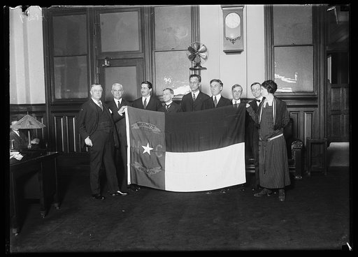 Harry S. New, left, and group with North Carolina state flag