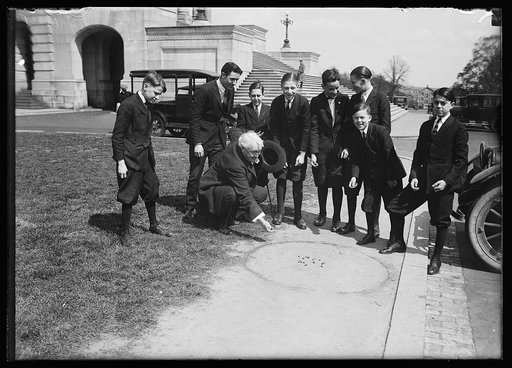 Group playing marbles outside U.S. Capitol, Washington, D.C.
