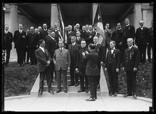 Senor Don Ceyetano de Quesada, Cuban Consul at Wash., receiving an honorary membership in Richard J. Harden Camp No. 2 of the United Spanish War Veterans at Cuban Embassy from William E. Rink. At the Consul's right is Jas. J. Murphy, Dept. Commander of the organization