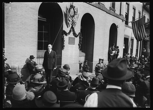 Rep. Henry C. Rathbone, of Ill., addressing the gathering at the unveiling of a tablet marking the old Ford Theatre where Lincoln was shot. The tablet was unveiled by Miss Mand Burr Morris