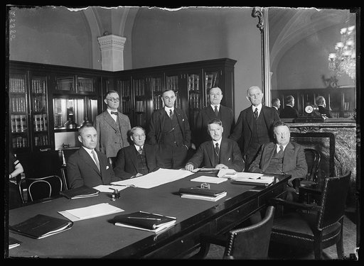 Privileges and elections committee of the Senate now hold hearings on the contest brought by Geo. E.U. Peddy for Senator Earl B. Mayfield's seat. Lft. to rt. seated: Senators M.M. Neely of W.Va., W.H. King, of Utah, S.P. Spencer, of Mo., and James E. Watson, of Ind. standing Lft to rt.: W.F. Zimmerm