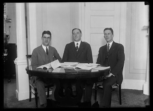 Dr. Marion Leroy Burton, Pres. of the Univ. of Michigan, who will make the speech putting Pres. Coolidge's nomination at the Cleveland Conv., conferring with Directors Royal C. Jordan, left, and Jack Hayes, right, of the College Bu. of the Republican Nat'l Committee. 200 college clubs have been orga