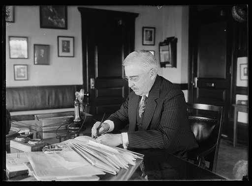 Exclusive: 1st picture to be made of the Chairman William M. Butler of the Republican Nat'l Comm. at his desk. For the 1st time in the Repub. Nat'l Comm. Headqtrs., Munsey Bldg., Wash. The picture was made Mon. morning, June 23rd. Chmn. Butler spent the weekend with Pres. Coolidge on the Presidentia