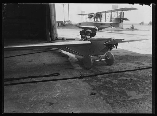 Child seated in small airplane