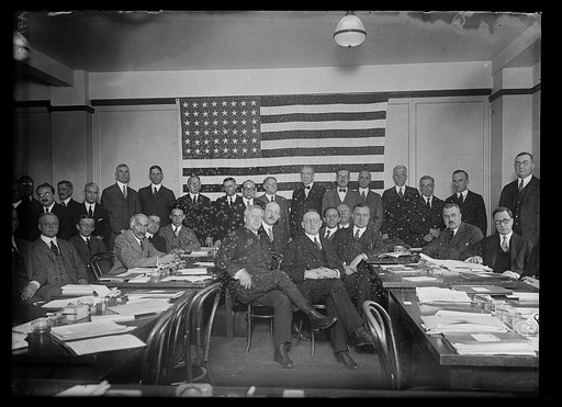 Group meeting; Curtis Wilbur, back row standing left of American flag