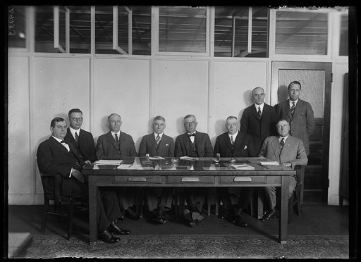 Group at table; Howard M. Gore, left