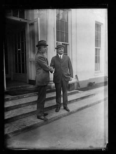 C. Bascom Slemp and Everett Sanders shaking hands outside White House, Washington, D.C.