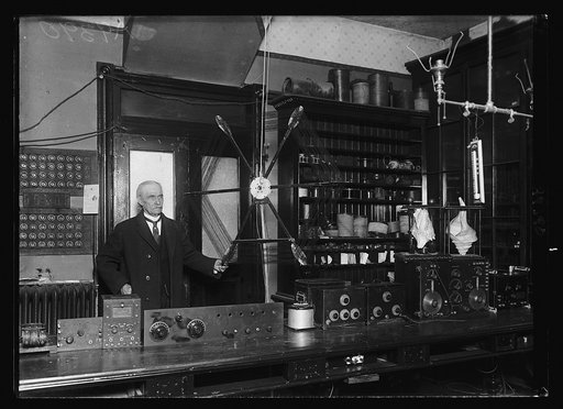 Dr. J. Harris Rogers, of Hyattsville, MD., inventor of underground and under water radio communication systems, is shown with the loop antenna he used recently in receiving signals from [...] the Atlantic Ocean, this loop was submerged as well