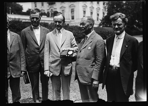 Coolidge and group outside White House, Washington, D.C.