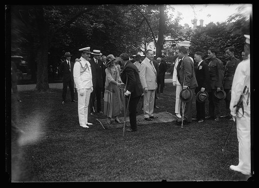 President and Mrs. Coolidge greet persons with crutches
