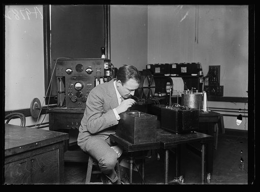 How to keep on your own wave length. Dr. J.H. Dellinger, Chief of the radio laboratory of the bureau of standards, is seen examining a frequency indicator, which is a device that enables radio broadcasting stations to keep on their respective wave lengths when broadcasting. This radio laboratory has