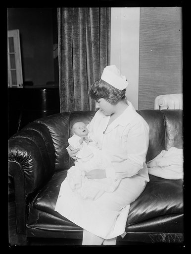 Nurse holding infant