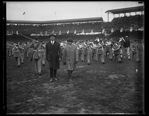Dwight Davis on field with marching band at ball park