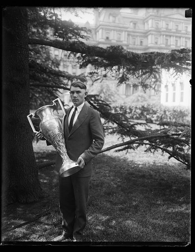 William Pat Boland, 17 years old, of Newberry County, South Carolina, with a $2,000 cup he won as first prize in a corn growing contest for boys in eight southern states. He called on President Coolidge today, May 13th