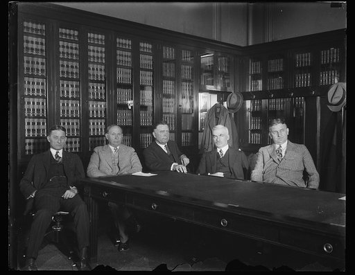 Group at table; William Borah, center