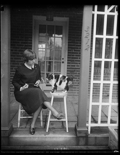 This "Kitty" belonged to the Sultan of Turkey. Mrs. Martin K. Metcalf, wife of Commander Metcalf, U.S.N., holding "Pansy" a thoroughbred Turkish cat who formerly did her "meowing" in the palace of the Sultan of Turkey. The cat, brought to Washington from Turkey by Commander Metcalf, is eight years o